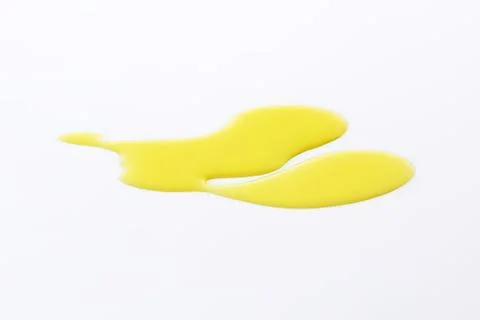 Yellow liquid or paint drop on surface Stock Photos