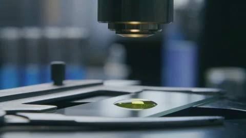 Yellow Liquid Sample on Slide Being Inspected under Microscope Stock Footage 315130204