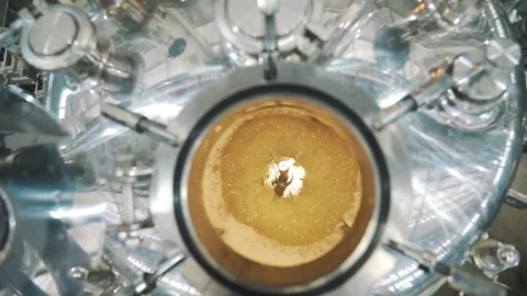 Yellow liquid in spinning machine pan from left to right Medium shot slow motion Video stock 159057442