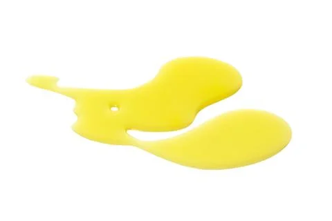 Yellow liquid splatter on white surface Stock-Fotos