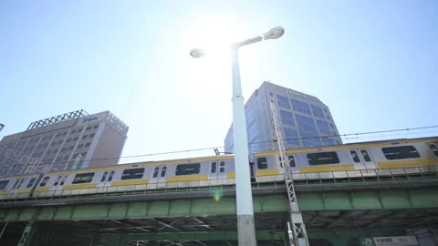 Yellow local train leaves the station in Tokyo Japan. Stock Footage 220095687
