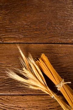 Yellow long spaghetti integral on a rustic background. Yellow italian pasta. Stock Photos