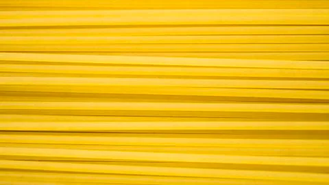 Yellow long spaghetti. Thin pasta arranged in rows. Yellow italian pasta.  Stock Photos