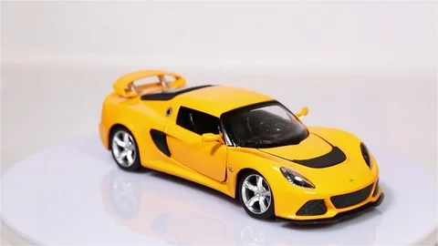 Yellow Lotus Exiges scale model sports car is rotating isolated Video stock 101774031
