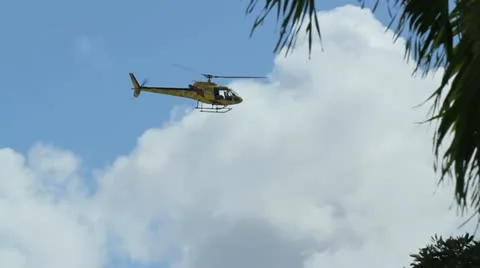 Yellow low flying helicopter Stock Footage 12117530