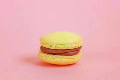 Yellow macaron on pink background Stock Photos