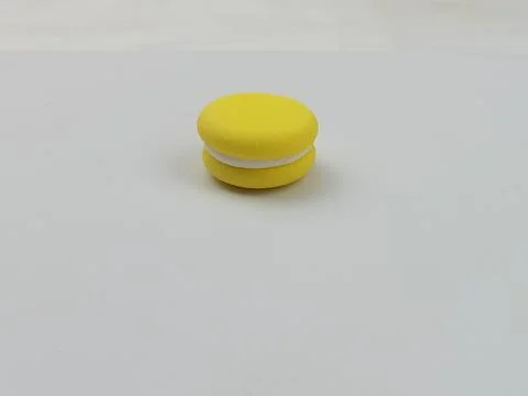 Yellow macaron on white background, minimal dessert concept Stock Photos