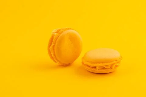 Yellow macarons on a yellow background create vibrancy Stock Photos
