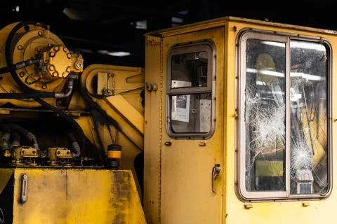 A yellow machine with a broken window Stock Photos