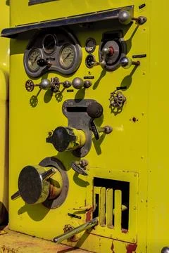 A yellow machine with a lot of knobs and dials Fotos de archivo