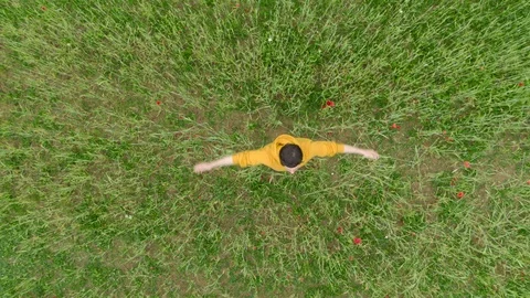 Yellow man spinning on the grass Stock Footage 105410288