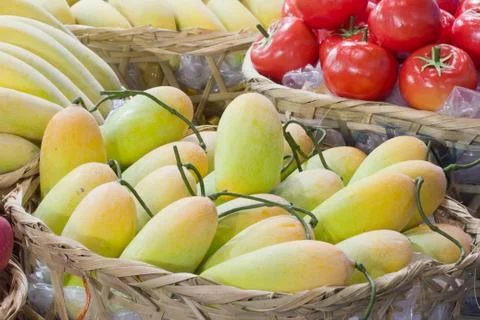 Yellow mango in bamboo basket Stock Photos