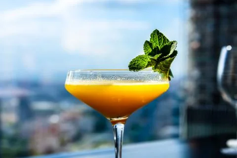 Yellow mango cocktail with mint leaf in a glass. Stock Photos