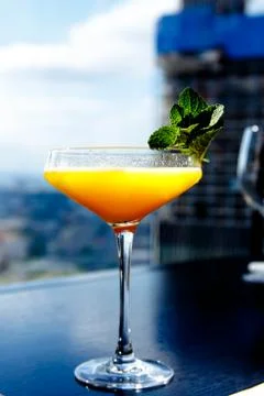 Yellow mango cocktail with mint leaf in a glass. Stock Photos