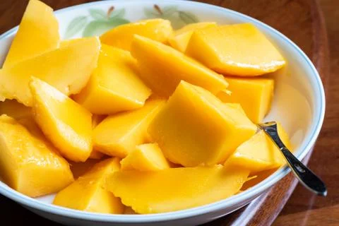 Yellow mango on a dish Stock Photos