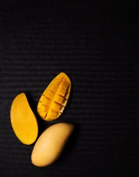 Yellow mango fruit on black Stock Photos