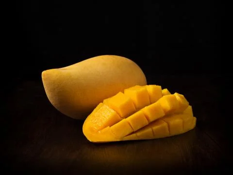 Yellow mango fruit on black Stock Photos