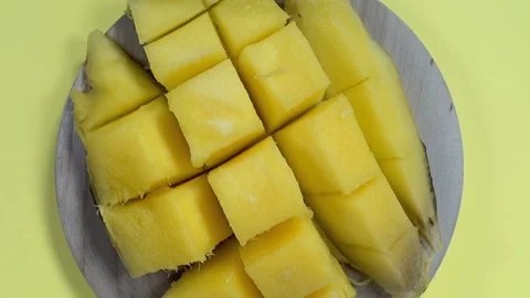 Yellow mango fruit cut into cubes Stock Footage 143421222