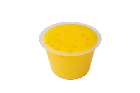 Yellow mango pudding, sweet mango mousse dessert in plastic cup Stock Photos