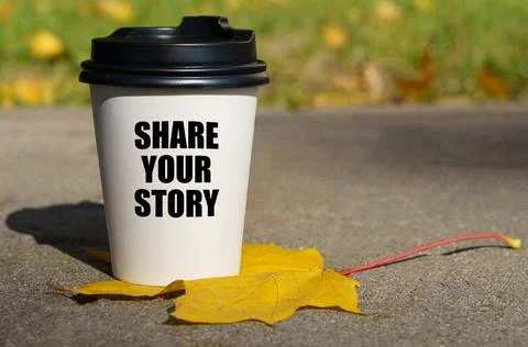 On a yellow maple leaf there is a cup of coffee on which is written - share y 写真素材
