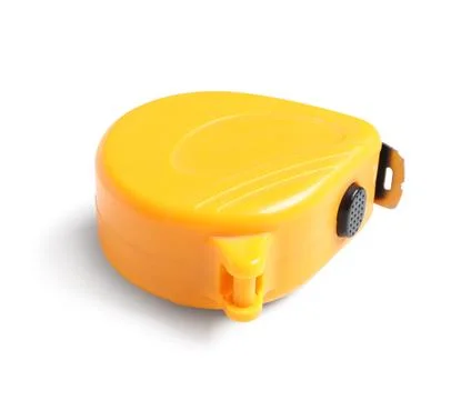 Yellow measuring tape with a black button and metal hook, construction and DI Stock Photos