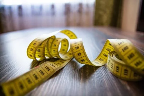 Yellow measuring tape of the tailor. Stock Photos