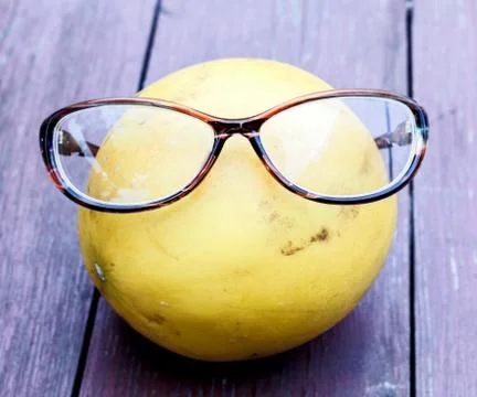 Yellow melon with glasses Stock Photos