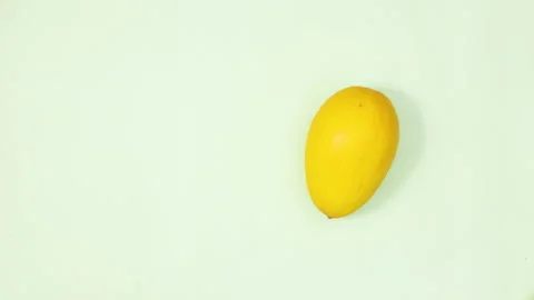 Yellow melon rotating on light green background. Stop motion flay lay 스톡 동영상 154524989