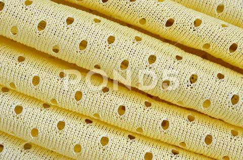 Yellow mesh sport wear fabric textile background pattern Stock Photos