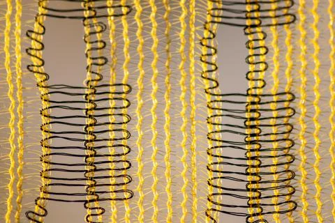 Yellow mesh structure in close-up with backlight on shiny abstract pattern Stock Photos