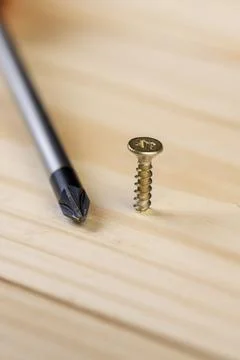 Yellow metal self tapping screws for fastening are used in construction Stock Photos