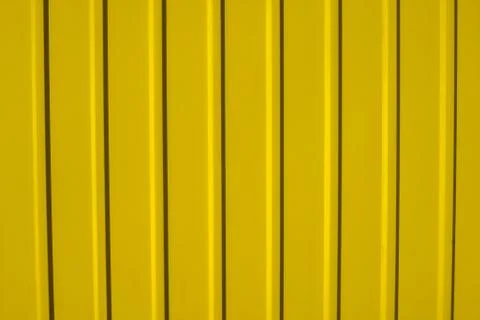 Yellow metal sheet panel or cladding with vertical line wave pattern. Stock Photos