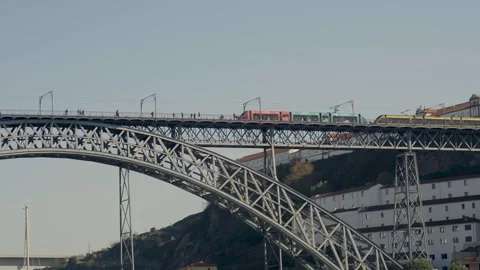 Yellow metro train crossing the upper deck of the Dom Luis I bridge. Stock Footage 327624827