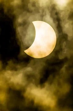 A yellow moon is in the sky with a dark cloud Fotos Stock