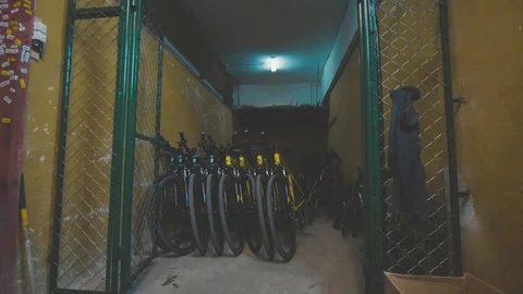 Yellow mountain bikes stacked up in a workshop Stock Footage 88762941