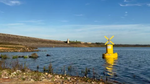 A Yellow Navigation Buoy Floats In Shallow Water In A Reservoir Video stock 265596578