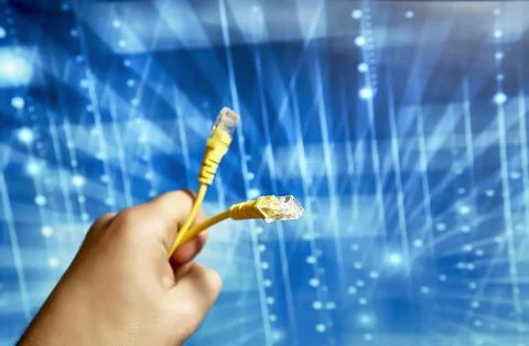 Yellow network cable with rj-45 connector on a blue background Stock Photos
