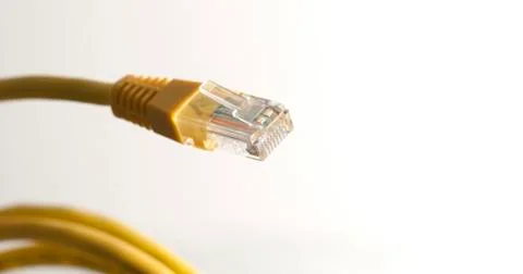 Yellow network cable with rj45 connector on white background Stock Photos