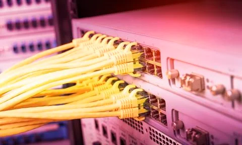 Yellow network cable in switch and firewall in cloud computing data center se Stock Photos