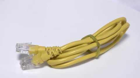 Yellow networking cable on white surface Stock Footage 111887699