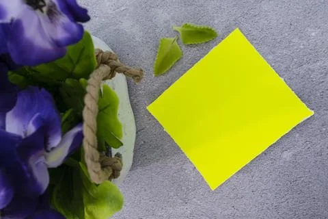 Yellow note with flowers the desk. Flat lay. Copy space. Stock Photos