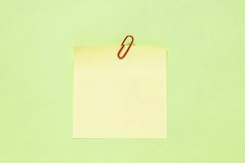 A yellow note on a green background Stock Photos