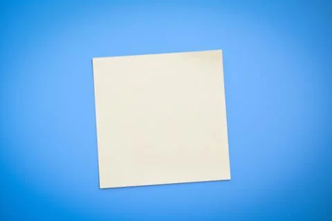 Yellow note over blue background Stock Photos
