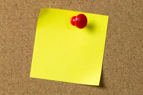 Yellow note pad attached to corkboard Stock Photos