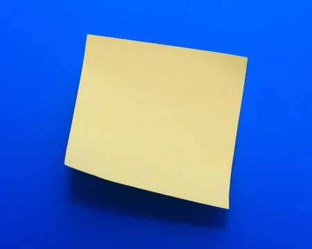 Yellow note paper on a blue background Stock Photos