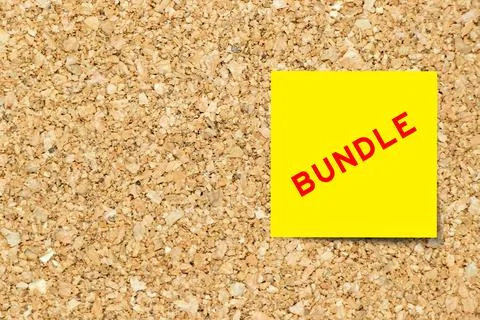 Yellow note paper with word bundle on cork board background with copy space Foto stock