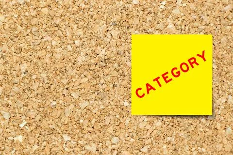 Yellow note paper with word category on cork board background with copy space Stock Photos