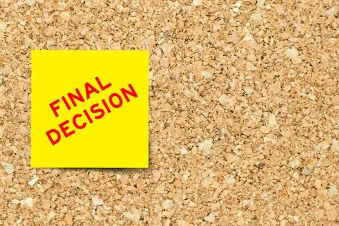 Yellow note paper with word final decision on cork board background with co.. Stock Photos