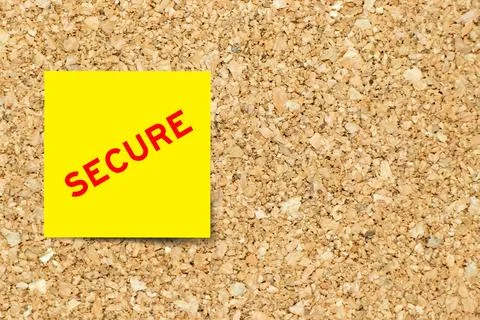 Yellow note paper with word secure on cork board background with copy space 스톡 사진