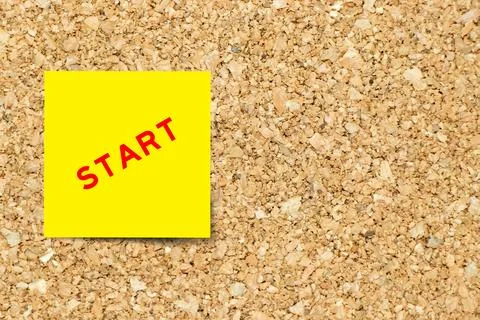 Yellow note paper with word start on cork board background with copy space 写真素材